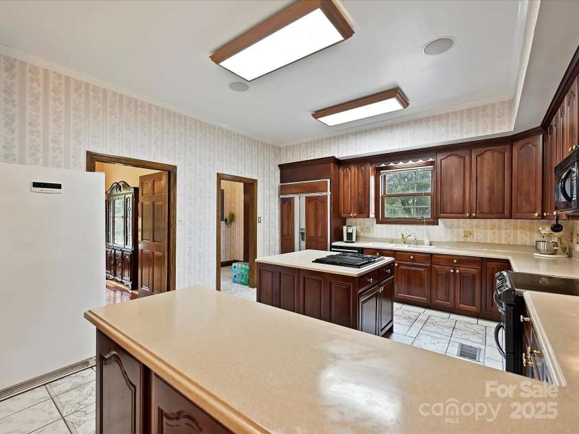 4900 Rocky River Road, Charlotte, NC 28215.  MLS# CAR4283934, YatesRealty ID 31470. Kitchen showing entry to side mudroom & full bath