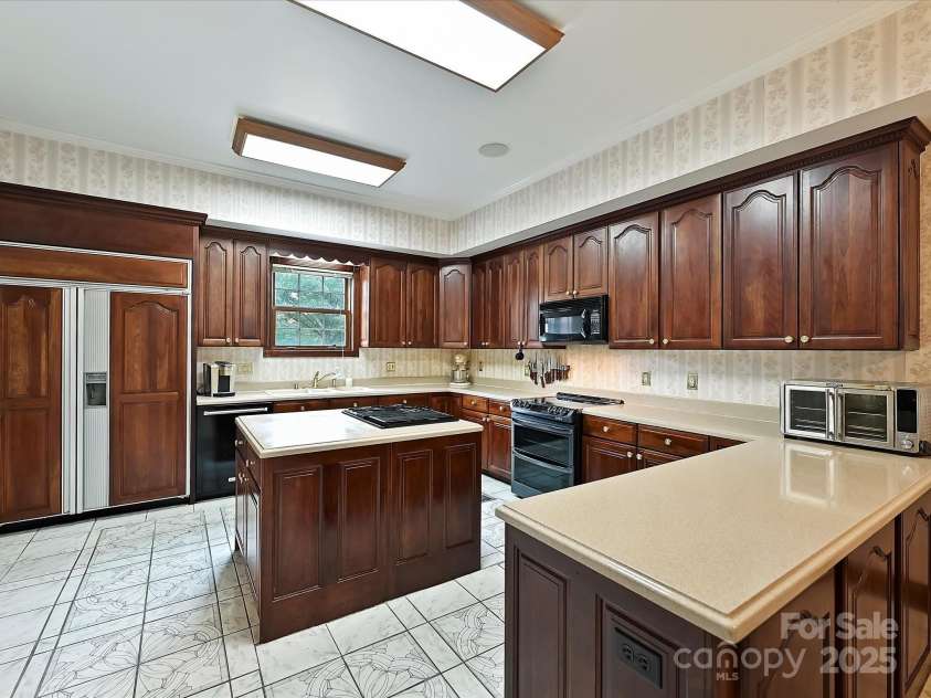 4900 Rocky River Road, Charlotte, NC 28215.  MLS# CAR4283934, YatesRealty ID 31470. Kitchen showing Sub Zero refrigerator