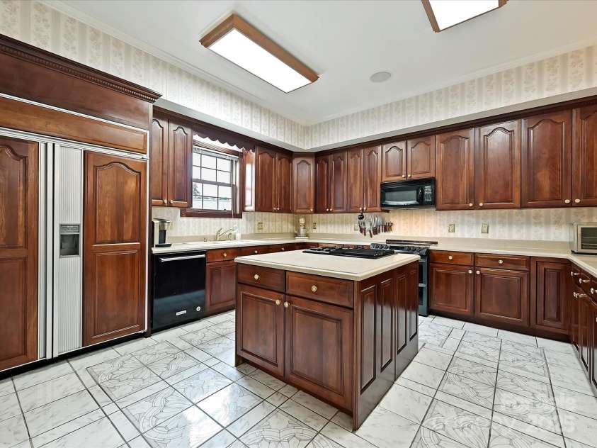 4900 Rocky River Road, Charlotte, NC 28215.  MLS# CAR4283934, YatesRealty ID 31470. Large island houses the gas stove