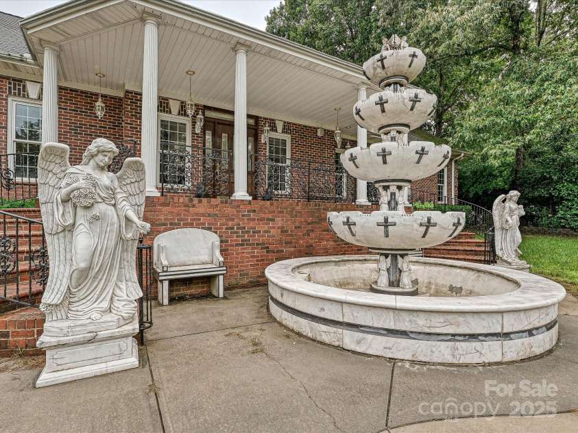 4900 Rocky River Road, Charlotte, NC 28215.  MLS# CAR4283934, YatesRealty ID 31470. Marble fountain, spiral steps leading to front door