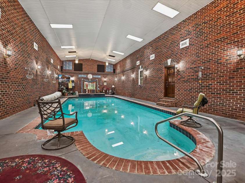 4900 Rocky River Road, Charlotte, NC 28215.  MLS# CAR4283934, YatesRealty ID 31470. Oversized inground heated indoor pool.