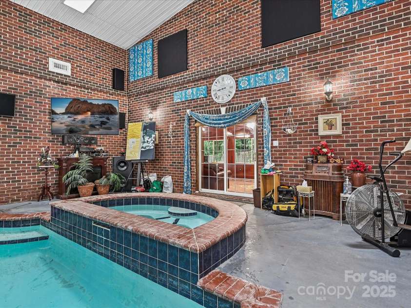 4900 Rocky River Road, Charlotte, NC 28215.  MLS# CAR4283934, YatesRealty ID 31470. Pool Spa and entryway to Solarium