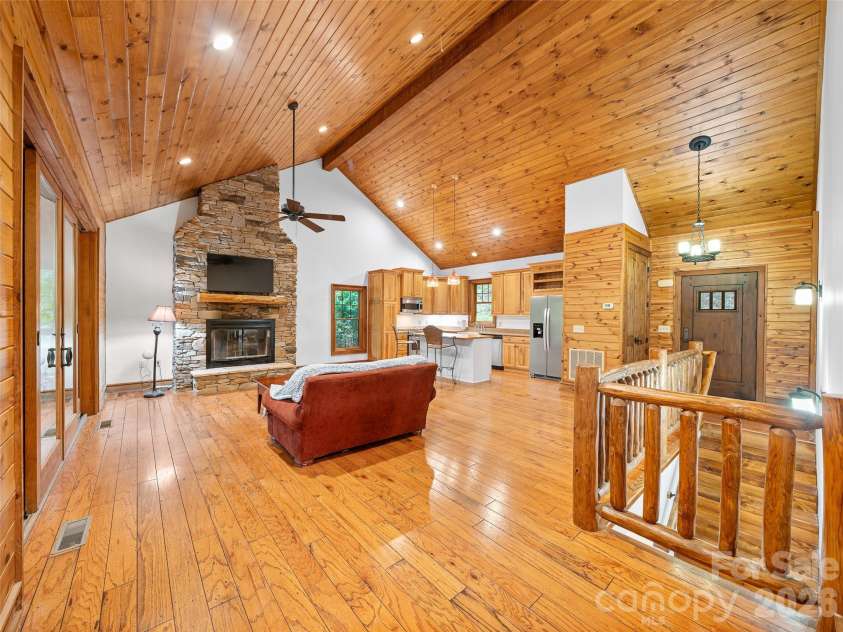 47 Falls Crossing Road, Burnsville, NC 28714.  MLS# CAR4393417, YatesRealty ID 31476. LIVINGROOM WITH VAULTED T&G CEILING