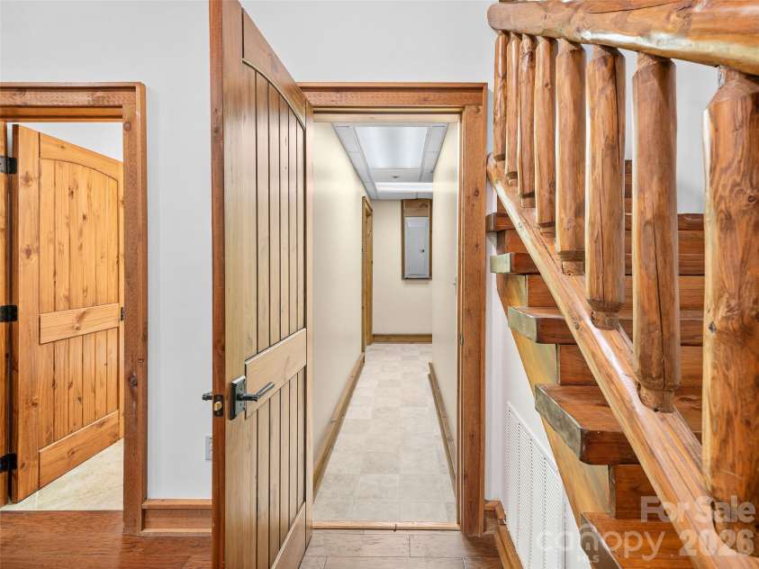 47 Falls Crossing Road, Burnsville, NC 28714.  MLS# CAR4393417, YatesRealty ID 31476. STAIRS AND STORAGE AREA - LOWER LEVEL