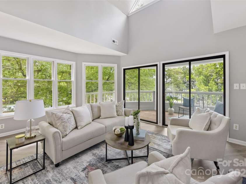 303 Northwest Drive, Davidson, NC 28036.  MLS# CAR4267438, YatesRealty ID 31490. Vaulted Great Room features wood burning fireplace, wet bar with built in glass shelving, skylight, large windows from end unit & double sliders to covered balcony with incredible Lake Norman views!