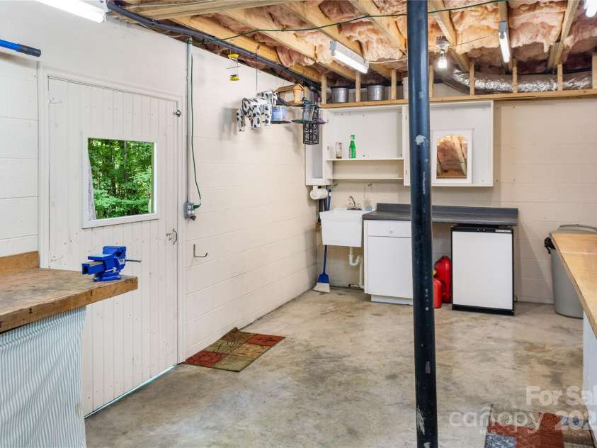 93 Hickory Drive, Maggie Valley, NC 28751.  MLS# CAR4290605, YatesRealty ID 31510. Oversized crawl space includes work shop space and storage