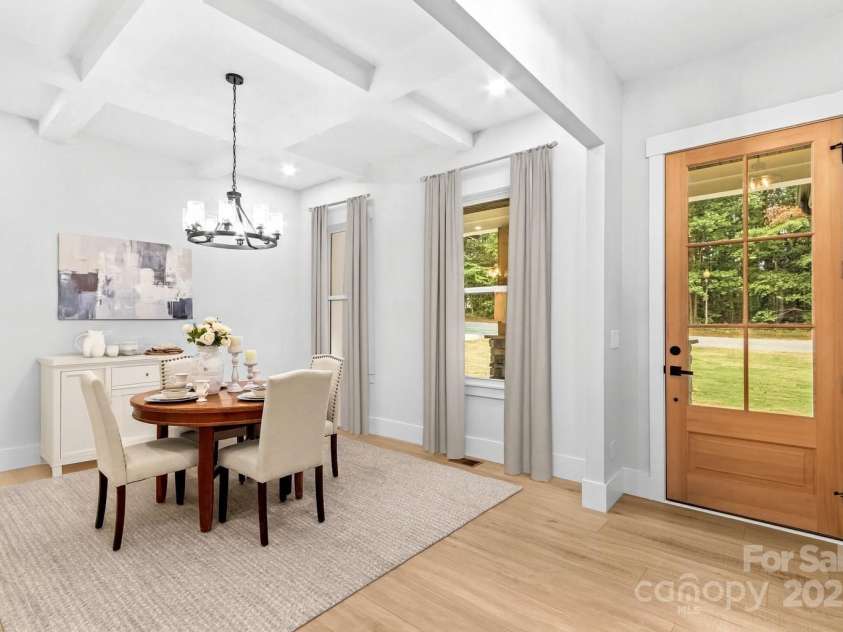 1075 Lake Wright Road, China Grove, NC 28023.  MLS# CAR4278354, YatesRealty ID 31532. Bonus Room could be formal Dining or Office. Notice the beautiful coffered ceiling. There are four dining areas in the home-Dining Room, Breakfast table area, Bar island seating & Screened Patio on back. Go ahead a