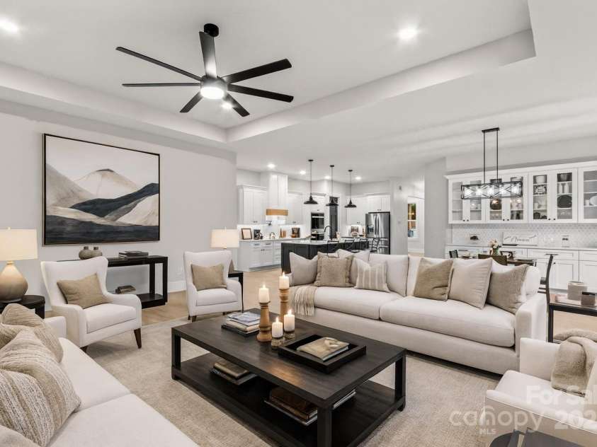 1075 Lake Wright Road, China Grove, NC 28023.  MLS# CAR4278354, YatesRealty ID 31532. Elegant open plan with large Kitchen, Den & Dining together. Notice the 11 ft tray ceiling.