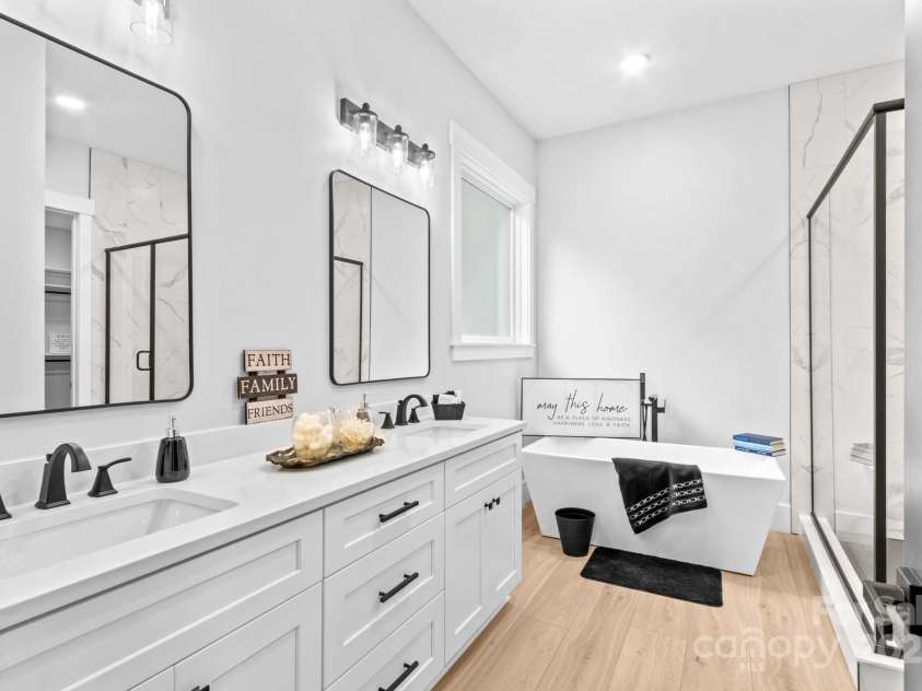 1075 Lake Wright Road, China Grove, NC 28023.  MLS# CAR4278354, YatesRealty ID 31532. Main Spa inspired Bath with quartz vanities & waterproof plank flooring, designer mirrors & upscale cabinetry.