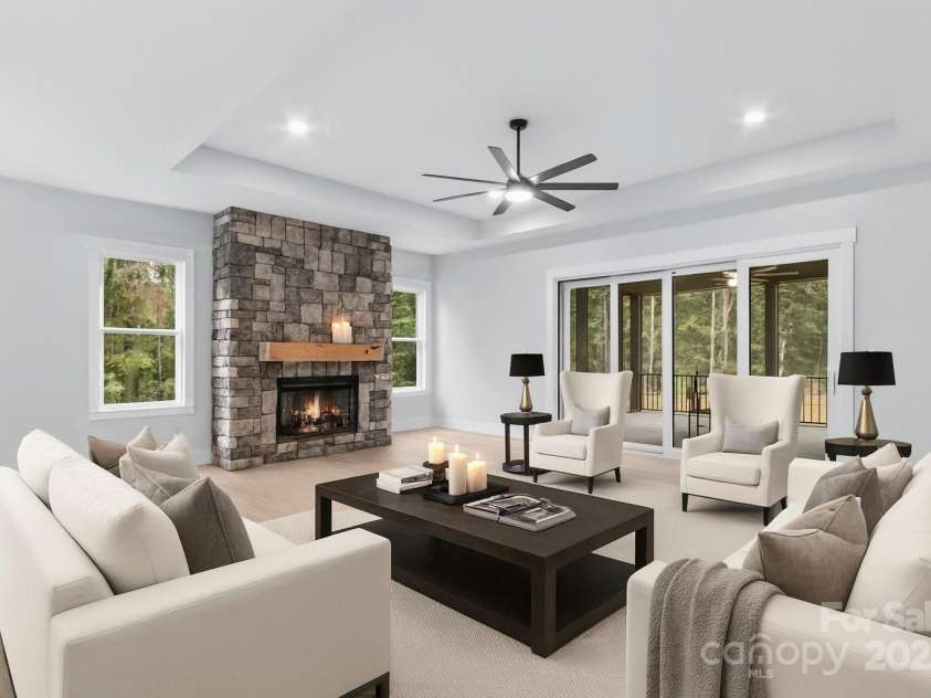 1075 Lake Wright Road, China Grove, NC 28023.  MLS# CAR4278354, YatesRealty ID 31532. Masterful architectural design like the great room with 11 ft tray ceiling, stone wall with electric fireplace, 8 ft tall sliding doors that open to screened Trex deck & upsale lighting.