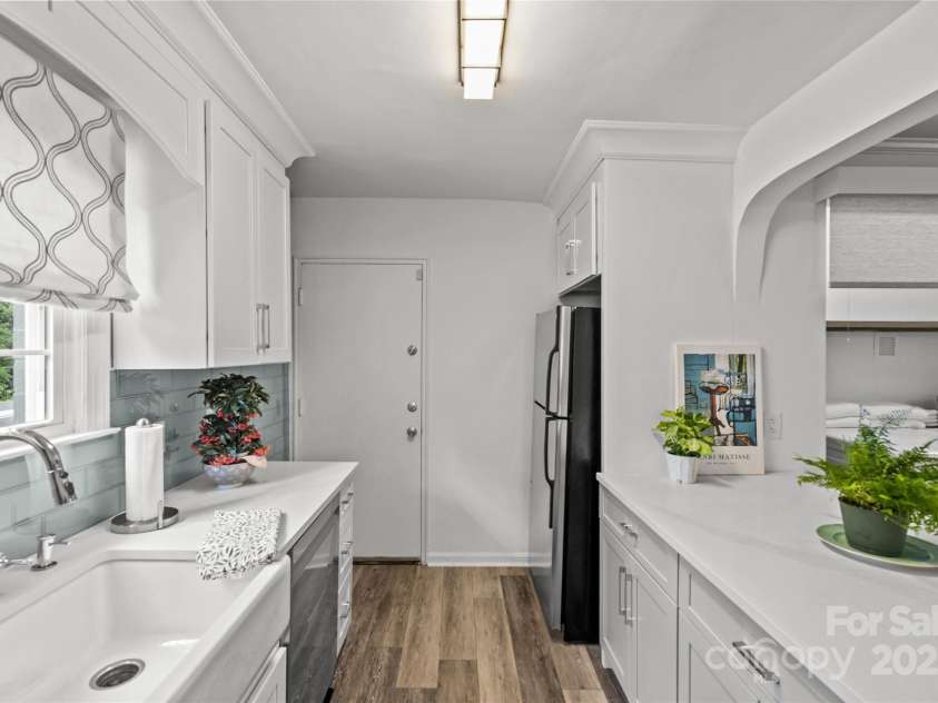 301 Wakefield Drive, Charlotte, NC 28209.  MLS# CAR4285273, YatesRealty ID 31534. Fridge is tucked out of the way next to the back door