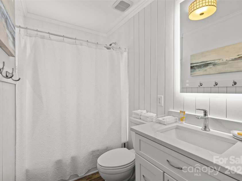 301 Wakefield Drive, Charlotte, NC 28209.  MLS# CAR4285273, YatesRealty ID 31534. Full bathroom with new tub/shower, tile and vanity with backlit mirror