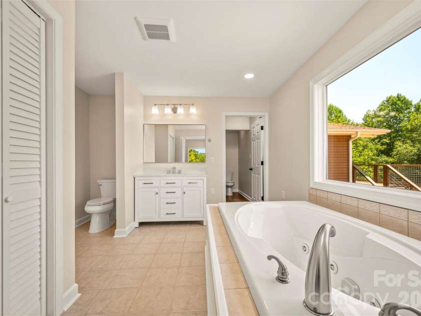 5732 Nc 9 Highway, Tryon, NC 28782.  MLS# CAR4395591, YatesRealty ID 31544. Main bathroom with washer/dryer hookup