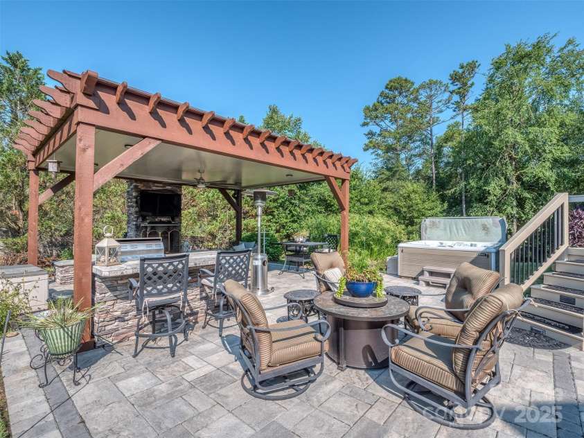 1377 Shinnecock Lane, Fort Mill, SC 29707.  MLS# CAR4273479, YatesRealty ID 31557. Covered Outdoor Kitchen with Grill, Fireplace, Outdoor TV, HUGE Paver Patio, Hot Tub, Flowing Fountain, & Complete Privacy!