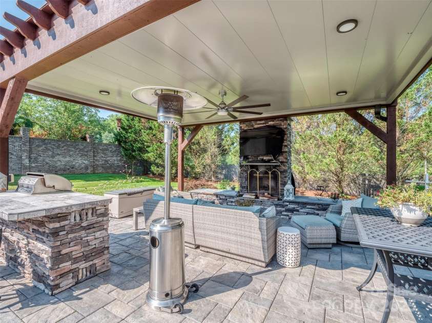 1377 Shinnecock Lane, Fort Mill, SC 29707.  MLS# CAR4273479, YatesRealty ID 31557. Covered Outdoor Kitchen with Grill, Fireplace, Outdoor TV, HUGE Paver Patio, Hot Tub, Flowing Fountain, & Complete Privacy!