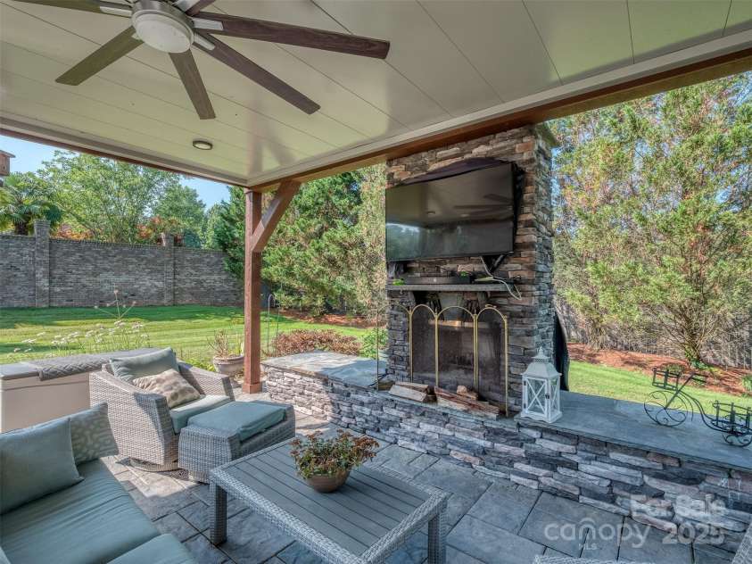 1377 Shinnecock Lane, Fort Mill, SC 29707.  MLS# CAR4273479, YatesRealty ID 31557. Covered Outdoor Kitchen with Grill, Fireplace, Outdoor TV, HUGE Paver Patio, Hot Tub, Flowing Fountain, & Complete Privacy!