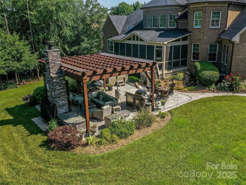 1377 Shinnecock Lane, Fort Mill, SC 29707.  MLS# CAR4273479, YatesRealty ID 31557. Covered Outdoor Kitchen with Grill, Fireplace, Outdoor TV, HUGE Paver Patio, Hot Tub, Flowing Fountain, & Complete Privacy!