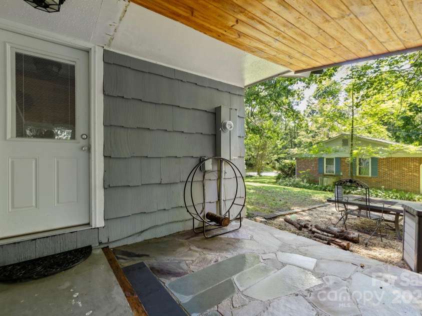 150 Deerwoode Lane, Brevard, NC 28712.  MLS# CAR4257546, YatesRealty ID 31558. Covered Back Patio