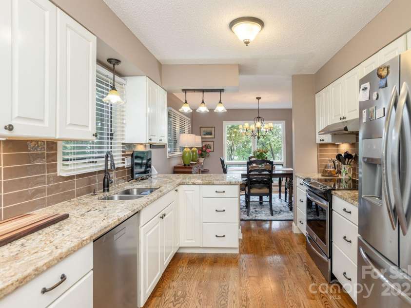 210 Claymoor Court, Flat Rock, NC 28731.  MLS# CAR4289864, YatesRealty ID 31569. Granite countertops with tile backsplash