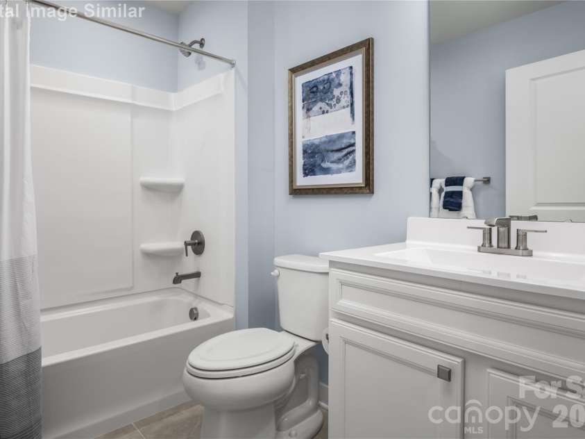 3283 Eller Drive Extension, Hickory, NC 28602.  MLS# CAR4340971, YatesRealty ID 3157. Bright, inviting shared bathroom with a tub perfect for winding down.