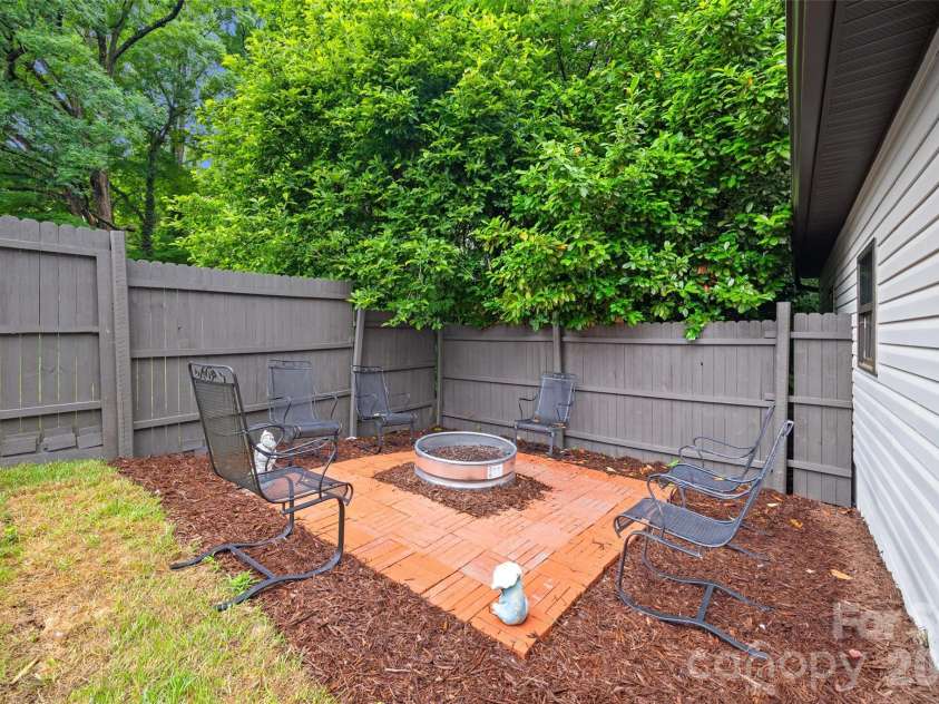 434 Sunnyside Drive, Concord, NC 28025.  MLS# CAR4380840, YatesRealty ID 31584. Nice fire pit or garden area behind garage.