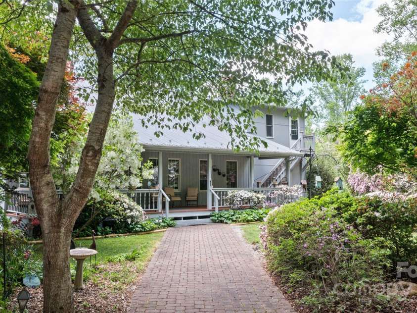 116 Sams Branch Road, Candler, NC 28715.  MLS# CAR4137587, YatesRealty ID 3165. Stroll through the gardens to the entry porch 