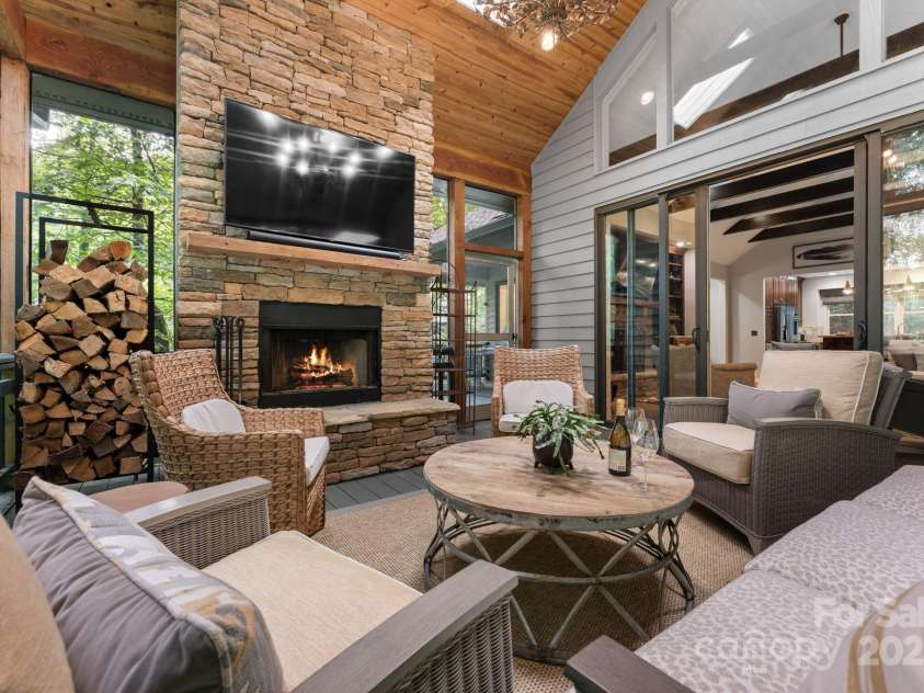 16 Hemlock Way, Highlands, NC 28741.  MLS# CAR4286772, YatesRealty ID 31668. Cozy Screened Porch with Wood-burning fireplace