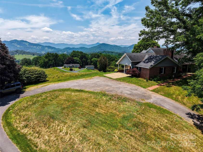 80 Gobblers Knob Drive, Clyde, NC 28721.  MLS# CAR4272798, YatesRealty ID 31672. Circular driveway, garage and double carport