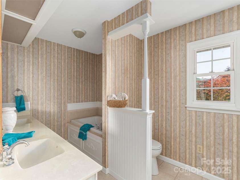 80 Gobblers Knob Drive, Clyde, NC 28721.  MLS# CAR4272798, YatesRealty ID 31672. Primary bathroom with extended double vanity, large tub and walk in shower