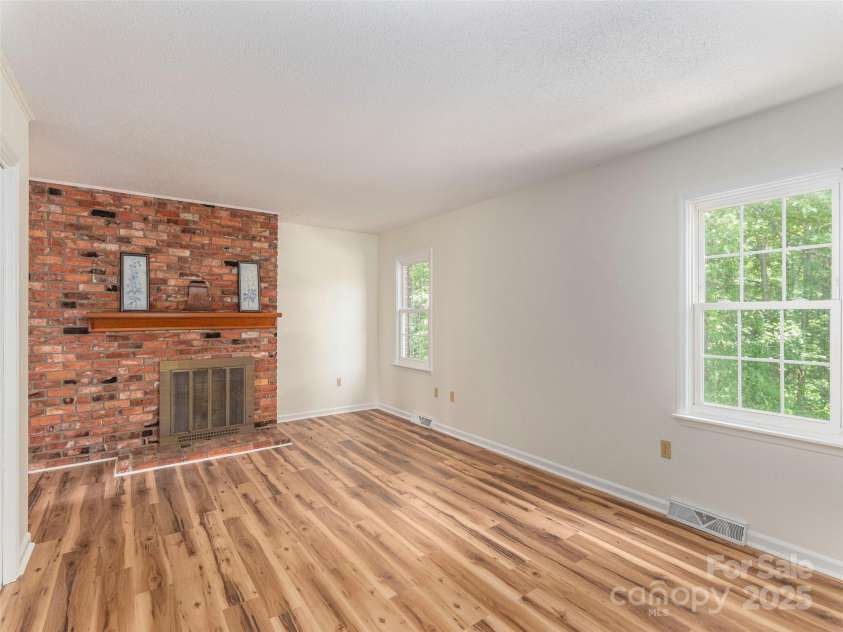 80 Gobblers Knob Drive, Clyde, NC 28721.  MLS# CAR4272798, YatesRealty ID 31672. Primary bedroom with fireplace