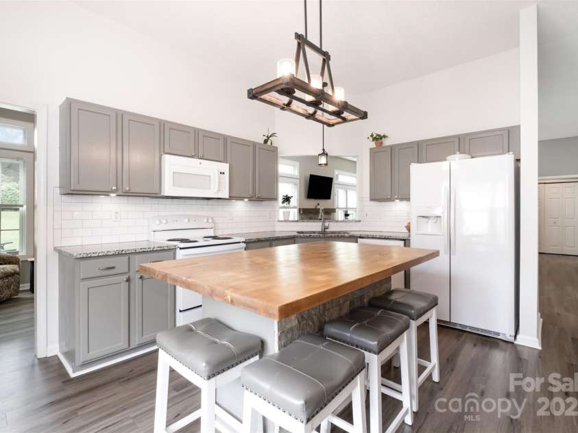 565 Viking Place, Concord, NC 28025.  MLS# CAR4288572, YatesRealty ID 31678. Butcher Block Island is so functional with sitting, storage, and food prep.