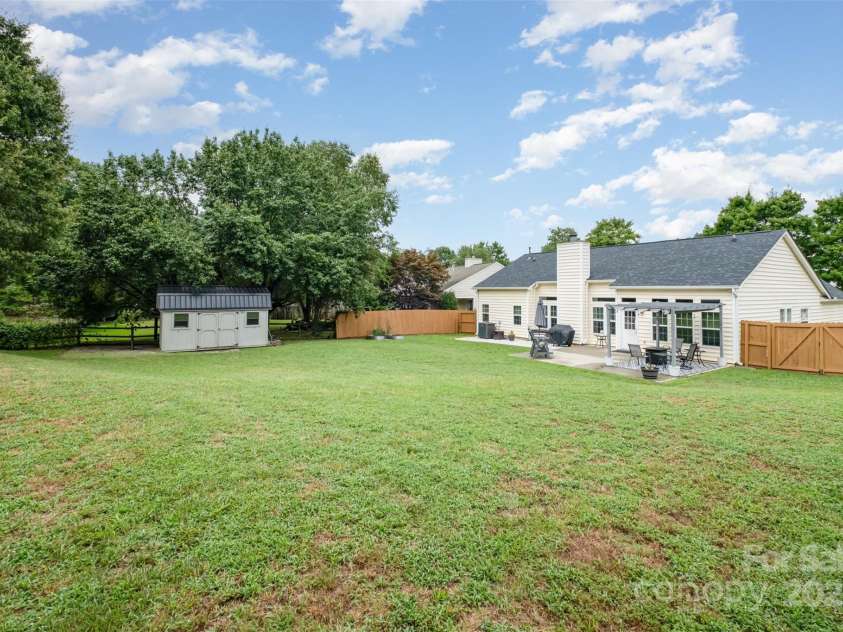 565 Viking Place, Concord, NC 28025.  MLS# CAR4288572, YatesRealty ID 31678. The 10 x 16 Metal Roof Storage Building is wired for the handy people