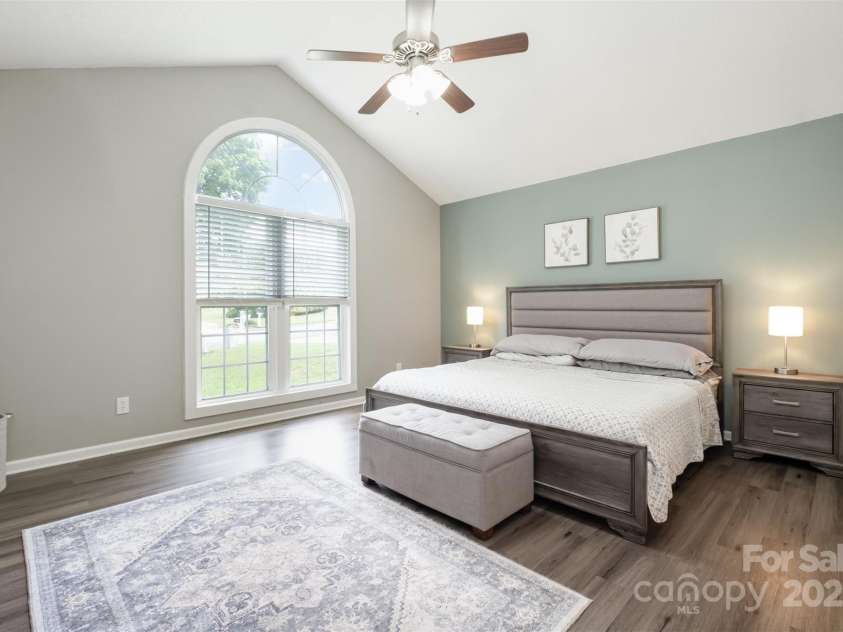 565 Viking Place, Concord, NC 28025.  MLS# CAR4288572, YatesRealty ID 31678. The Primary Bedroom is Impressive with the Vaulted Celing and large Half Round Picture Window. It allows the morning sun to welcome you to a new day