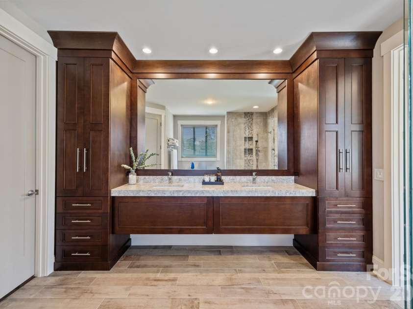 22304 John Gamble Road, Cornelius, NC 28031.  MLS# CAR4353501, YatesRealty ID 3169. Primary bathroom with storage under sinks