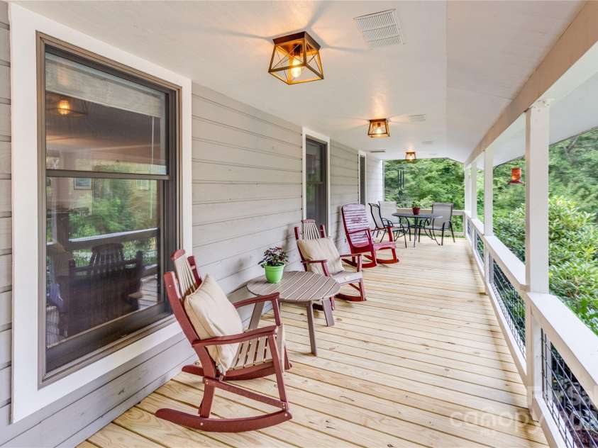 200 Crescent Drive, Lake Junaluska, NC 28745.  MLS# CAR4286284, YatesRealty ID 31693. Front porch views of the wide lawn with lake views and mountains beyond.