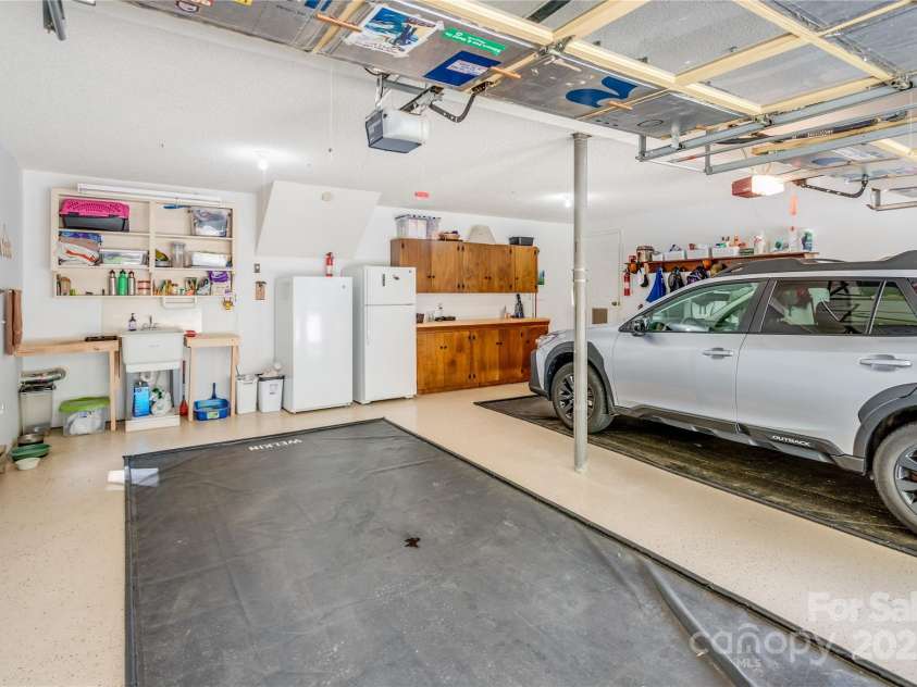 200 Crescent Drive, Lake Junaluska, NC 28745.  MLS# CAR4286284, YatesRealty ID 31693. Garage also has a side access door, utility sink, and cabinets.