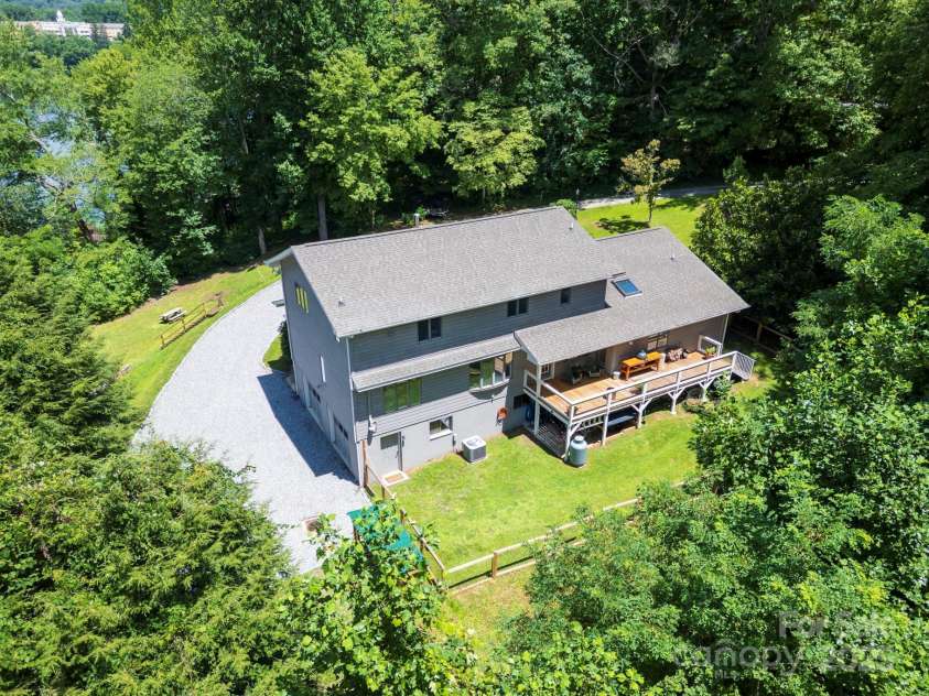 200 Crescent Drive, Lake Junaluska, NC 28745.  MLS# CAR4286284, YatesRealty ID 31693. Large deck is directly off the kitchen and ideal for grilling. Stairway leads down to backyard with new fencing that is accentuated by solar lights on top of the fence posts.