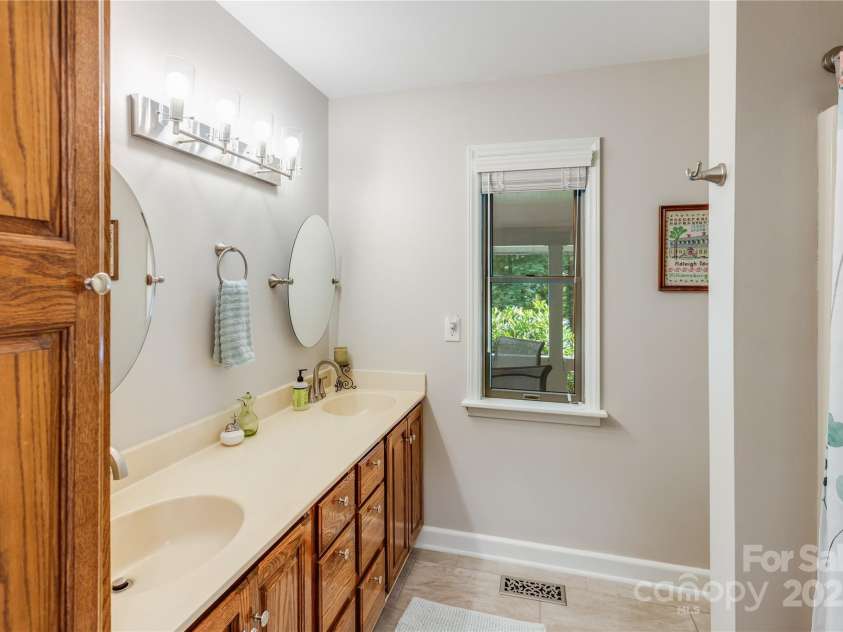 200 Crescent Drive, Lake Junaluska, NC 28745.  MLS# CAR4286284, YatesRealty ID 31693. Updated ensuite bath adds a touch of elegance to this primary suite.