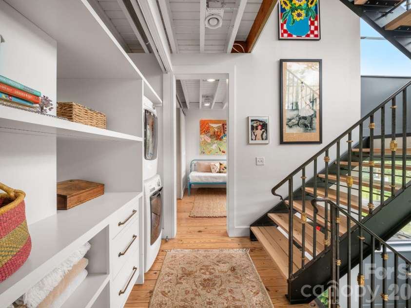 53 Buchanan Place, Asheville, NC 28801.  MLS# CAR4386804, YatesRealty ID 31695. Hall Laundry.  Pictured without doors.  Home will convey with doors can be added to hide laundry.