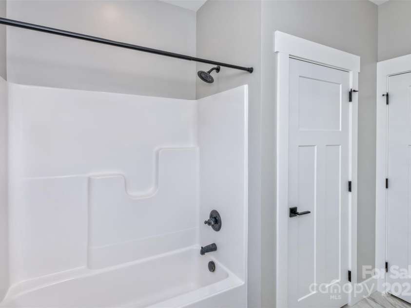 11 South Pine Drive, Weaverville, NC 28787.  MLS# CAR4274565, YatesRealty ID 31700. GUEST BATHROOM TUB & LINEN CLOSET