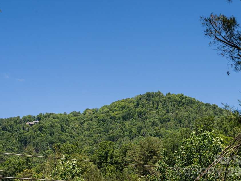1 Beaverdam Knoll Road, Asheville, NC 28804.  MLS# CAR4382855, YatesRealty ID 31734. Mountain view from front yard