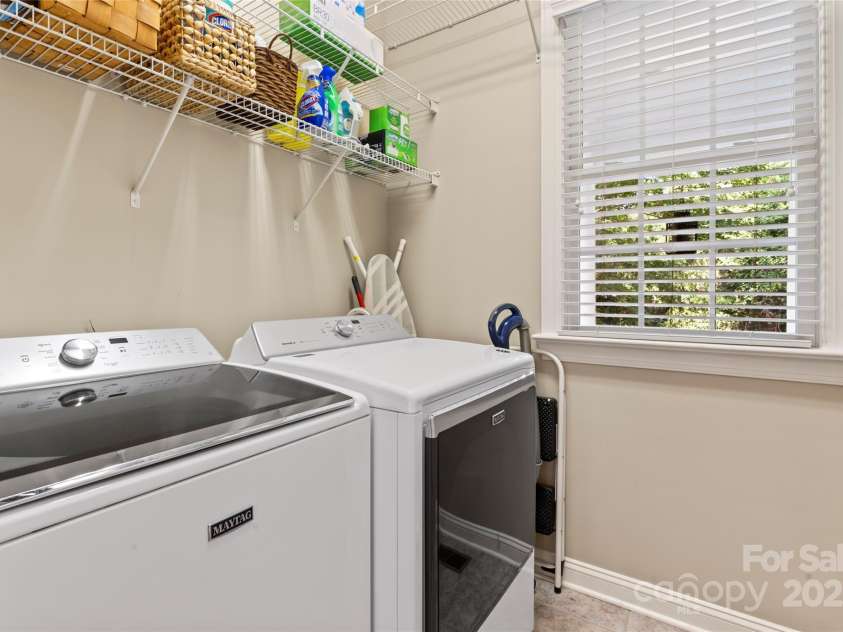 878 Promenade Walk, Fort Mill, SC 29708.  MLS# CAR4281286, YatesRealty ID 31755. Laundry room with shelving on the main floor.
