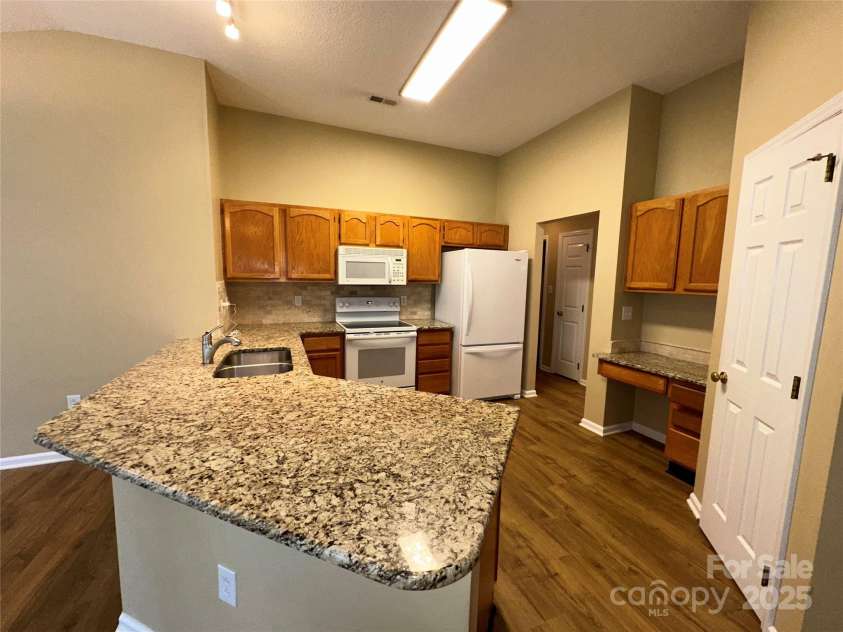 5416 Hedgecrest Place, Charlotte, NC 28269.  MLS# CAR4287168, YatesRealty ID 31760. Granite Kitchen (door is to Pantry)