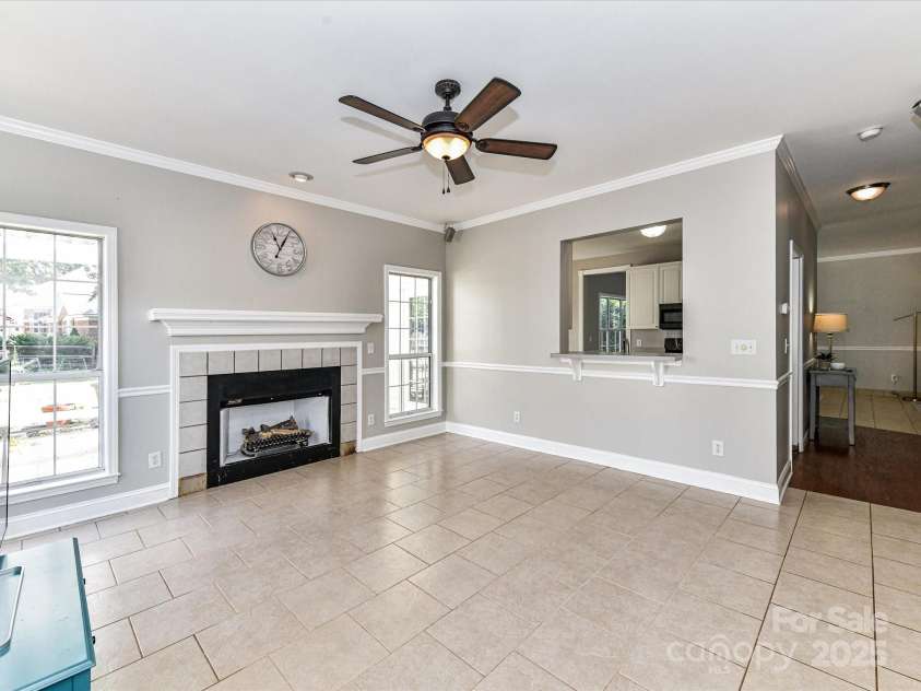 9029 Torrence Crossing Drive, Huntersville, NC 28078.  MLS# CAR4275401, YatesRealty ID 31784. Great Room features fireplace with gas logs (need to be connected), crown molding, ceiling fan/light, plentiful natural light & tile floors!