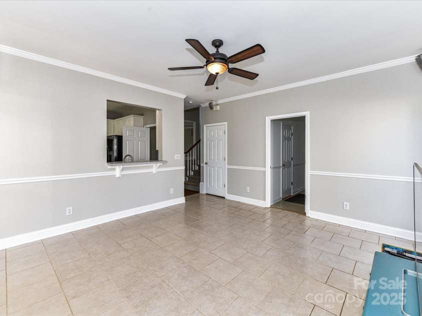 9029 Torrence Crossing Drive, Huntersville, NC 28078.  MLS# CAR4275401, YatesRealty ID 31784. Great Room features fireplace with gas logs (need to be connected), crown molding, ceiling fan/light, plentiful natural light & tile floors!