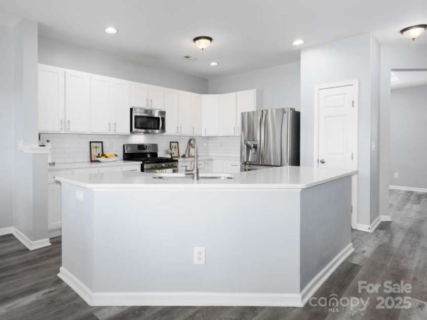 18547 The Commons Boulevard, Cornelius, NC 28031.  MLS# CAR4284549, YatesRealty ID 31807. Entertainers delight with updated kitchen open to great room, eat in kitchen area and dining room with service bar or coffee nook.