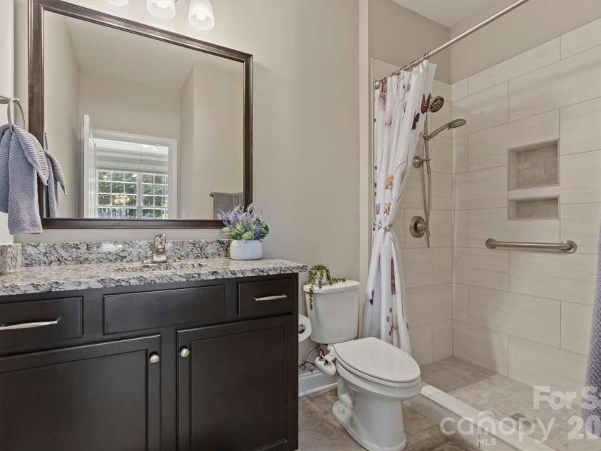 7658 Lazy Hollow Lane, Denver, NC 28037.  MLS# CAR4393866, YatesRealty ID 31812. Tiled ensuite bath with ADA accessibility