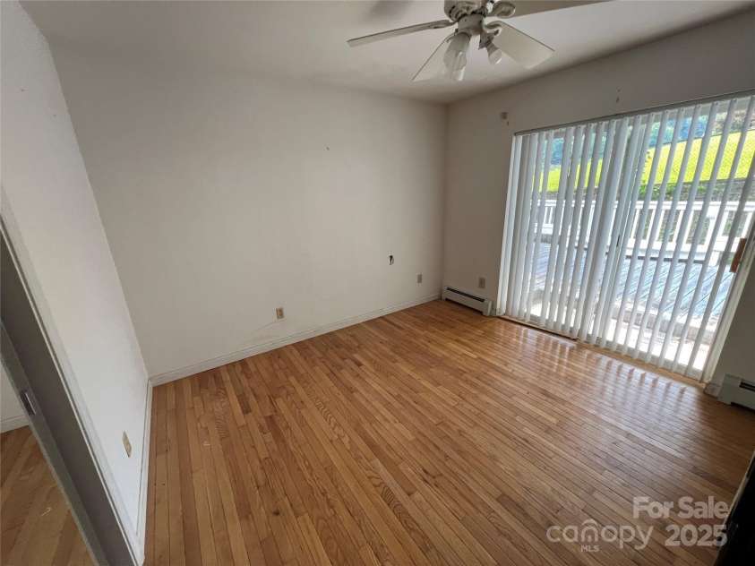 92 Mountain View Road, Burnsville, NC 28714.  MLS# CAR4278979, YatesRealty ID 31832. Bedroom w/half bath, sliding doors