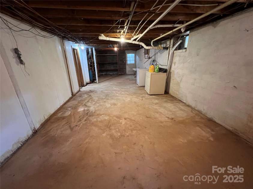 92 Mountain View Road, Burnsville, NC 28714.  MLS# CAR4278979, YatesRealty ID 31832. Unfinished part of basement w/laundry