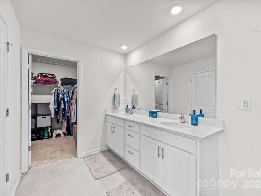 183 Marathon Lane, Candler, NC 28715.  MLS# CAR4284334, YatesRealty ID 31833. Primary bathroom with water closet, shower, dual vanity, and walk-in closet.